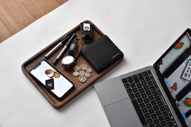 A laptop on a desk with purse, phone neatly arranged on a tray. This is used for the post 110 Common Mistakes to Avoid While Taking Online Survey on One Happy Amma