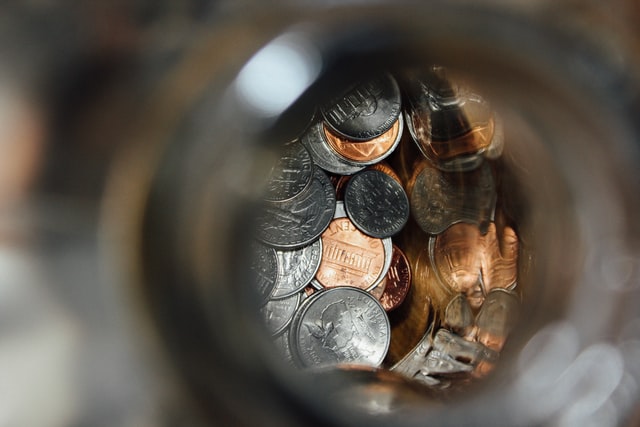 A lot of Coins in a bottle taken from top view from Unsplash used for 10 Common Mistakes to Avoid While Taking Online Survey